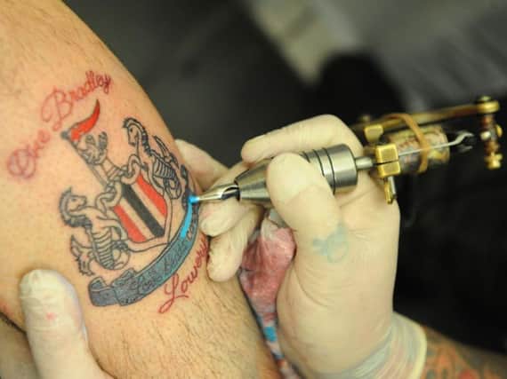 Eddie Goodwin gets his tattoo.