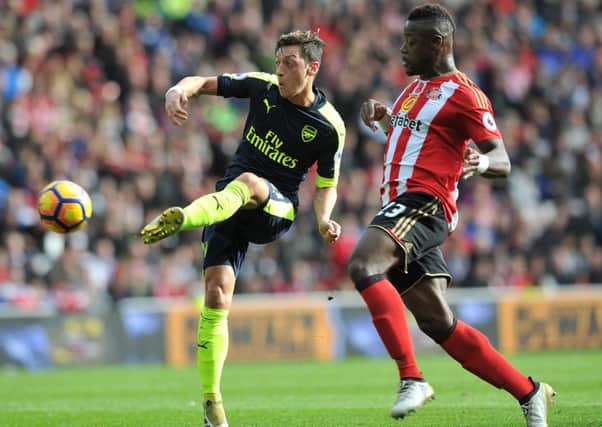 Arsenal's Mesut Ozil tries and fails to lob onrushing Sunderland keeper Jordan Pickford on Saturday, after getting clear of defender Lamine Kone. Picture by Frank Reid