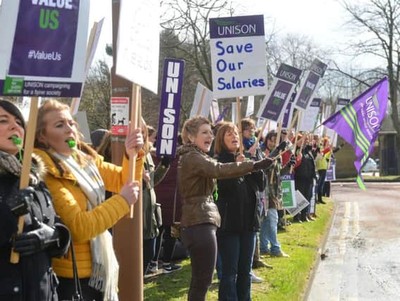 Teaching assistants protest outside Durham's County Hall.