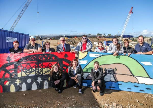 Pupils from Barbara Priestman Academy, present artwork to the New Wear Crossing site in Sunderland. Pictured with the pupils are; far left, Farrans Construction Training and Development Manager Joanne Lennox; second from the left, art teacher, David Fudge; centre left, Deputy Leader of Sunderland City Council Harry Trueman; second right, Farrans Construction Community Engagement Manager, Brigid McGuigan, and Barbara Priestman Academy D&T technician, John Donoghue.