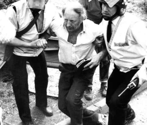 Arthur Scargill, pictured in June 1984, being assisted by riot police after he was injured outside the Orgreave Coking Plant near Rotherham during the miners' dispute.
