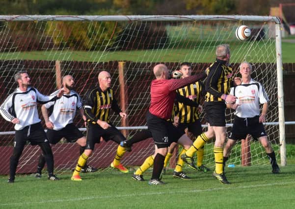 Seaham Marlborough (white) defend against Dubmire (yellow/black) at Dawdon Welfare Park last week. Picture by Kevin Brady