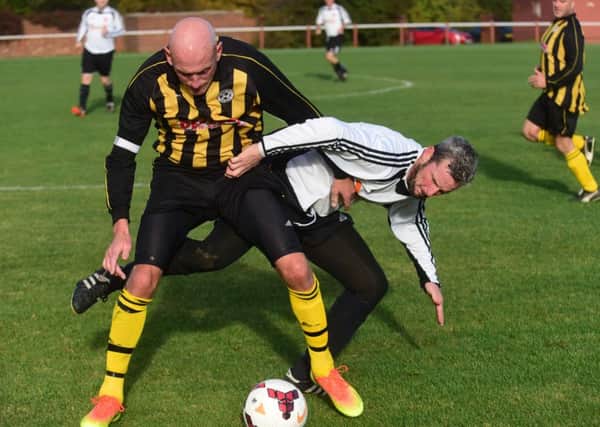 Seaham Marlborough (white) battle Dubmire (yellow/black) in the Over-40s League last weekend. Picture by Kevin Brady