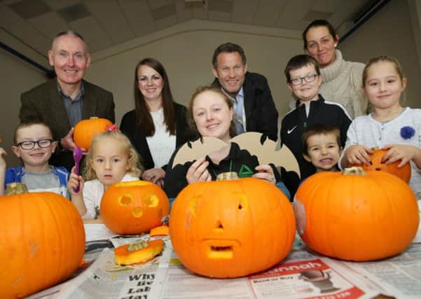 With some of the carved pumpkins are, back from left, Isos community involvement officer John Temple, parent Lauren Cousins, Cestria community investment officer Paul Hadden, parent Amanda Adamson and Keane Boardman, with front from left, Bryce Gillespie, Lily Cousins, Groundwork project officer Karen Collins, Cohen Boardman and Paige Hughes.
