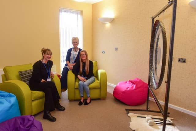 e" pictured in the sound therapy room l-r massage therapist Klare (correct) Ferry, parent carer Gemma Watson and sound therapist Sandra Hutchinson.