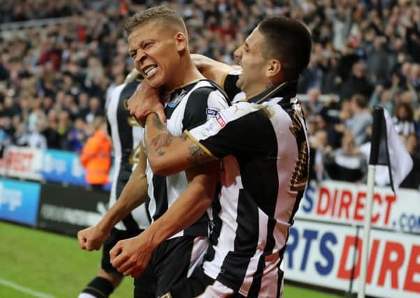 Newcastle United's Dwight Gayle (left) celebrates with Aleksandar Mitrovic after scoring his side's fourth goal of the game and completing his hat-trick during the Sky Bet Championship match at St James' Park, Newcastle. PRESS ASSOCIATION Photo.