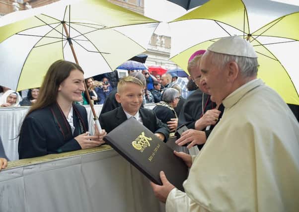 Harry Ellis and Lilly Thomson present the Children's Codex to Pope Francis in Rome.