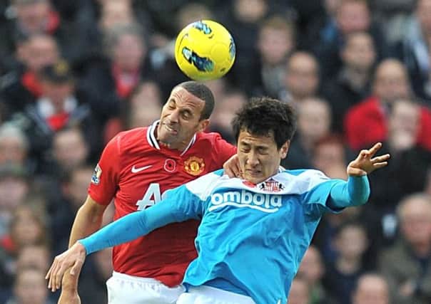 Sunderland striker Ji Dong-won battles against Rio Ferdinand at Old Trafford on this day five years ago