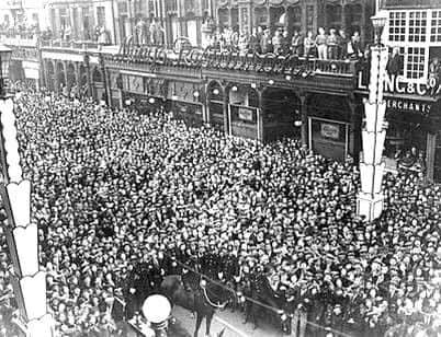 Crowds outside the Town Hall in 1937 with Meng's in the background.