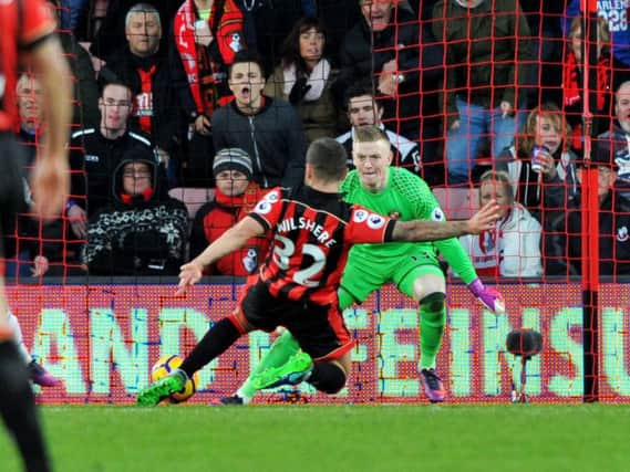 Jordan Pickford saves from Jack Wilshere at Bournemouth. Today the pair will be team-mates at St George's Park