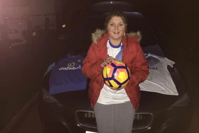 Leah Pratt with the SAFC jerseys and match ball from the Bournemouth v Sunderland game which she was given.