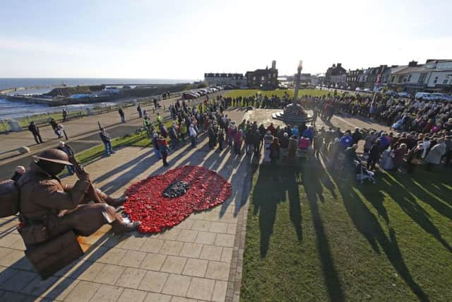 Hundreds turn out for a two minute silence at the Tommy statue in Seaham today for Armistice day . Photo Owen Humphreys, PA.