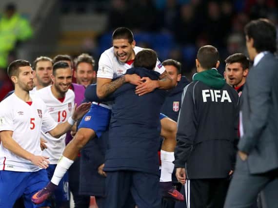 Serbia's Aleksandar Mitrovic celebrates scoring his side's equaliser against Wales last night. Pic: PA.