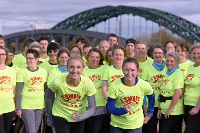 Paula Radcliffe, front left, and Alyson Dixon, front right, joined about 50 local runners in taking part in a flash mob style run around the city centre.