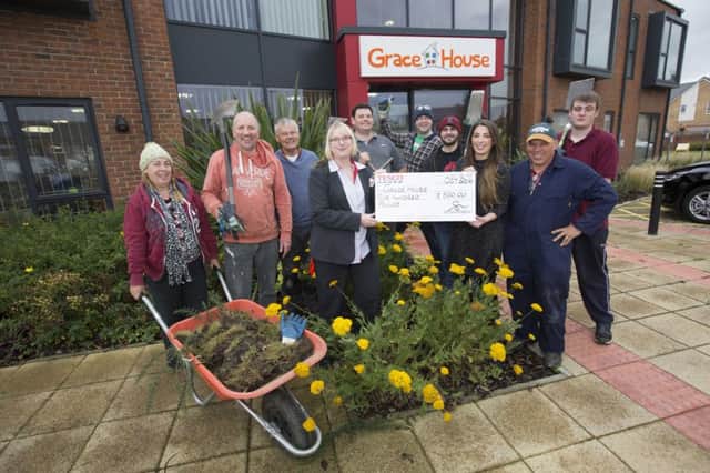 Tesco South Shields services manager Helen Craig and her team handing over a donation of Â£500 to Grace House manager Jane Lertas-Robinson after they volunteered their time to give the gardens a tidy up. Picture by John Millard