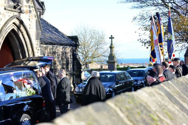 People gather outside Christ Church to pay their respects.