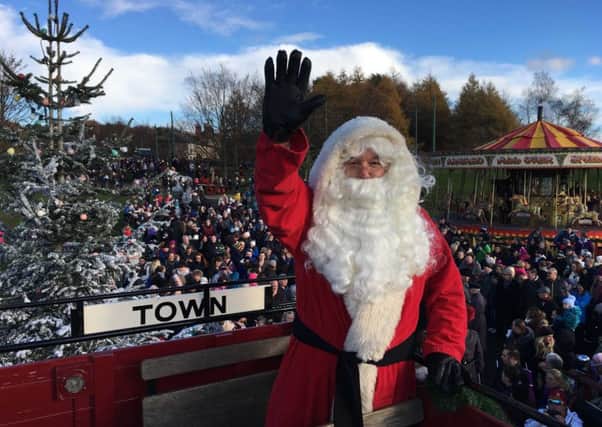 Father Christmas waves to the crowd at Beamish Museum.