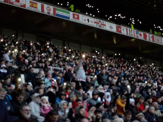Let there be (mobile phone) light: Fans bring their own light to the ground. Picture by FRANK REID