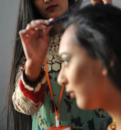 Thanjina Begum attends to Shahila Hussain's hair at the Diwali Celebrations at Sunderland Museum and Winter Gardens.