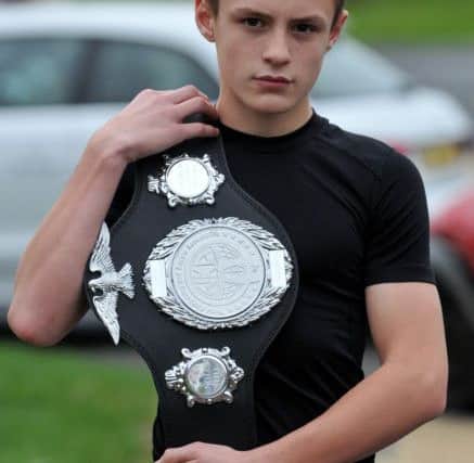 Kick Boxer Zach Marshall with his latest belt. Picture by FRANK REID
