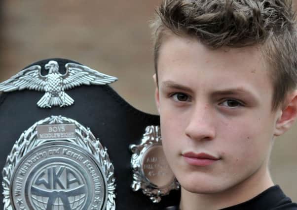 Kick Boxer Zach Marshall with his latest belt. Picture by FRANK REID