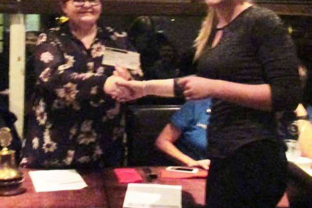 Sunderland High Leo Club president Amy Davison presents Amy Gormanley-Hudson, from Centrepoint, with a cheque.