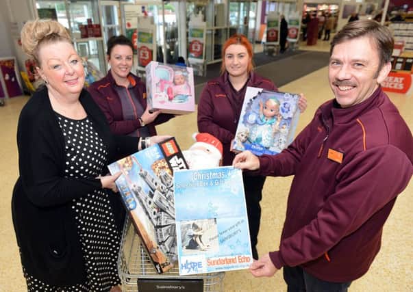 (left) Viv Watts, Chief Executive of Hope for Kids, is presented with toys by Sainsbury's Silksworth Lane staff (left to right) Helen Williamson, Helen Brown and Rob Fraser. Picture by FRANK REID
