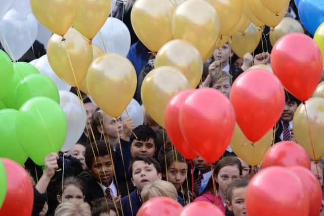 Pupils take part in Thornhill School Business and Enterprise College's 50th anniversary balloon release.