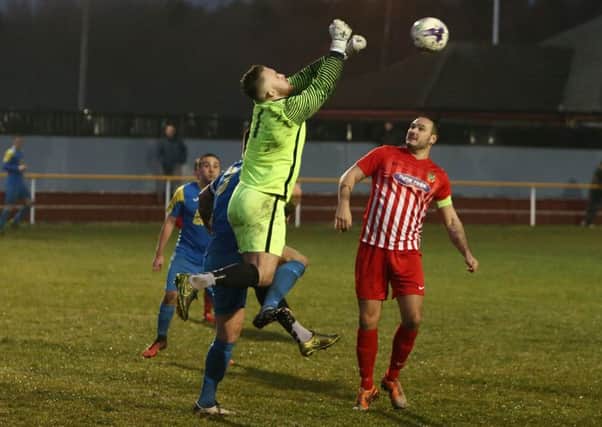 Ryhope CW Jonny Ball deals with a cross in Saturday's 3-3 Northern League draw at Jarrow Roofing, watched by skipper Leon Ryan. Pics by Tom Banks