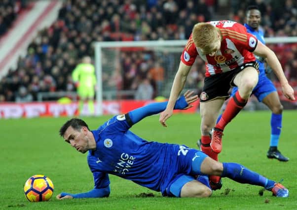 Duncan Watmore goes down under a challenge from Leicesters Christian Fuchs to sustain his injury. Picture by Frank Reid