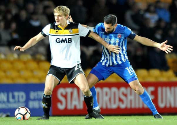 Pools' Billy Paynter (right) fights for the ball at Port Vale yesterday. Picture by Frank Reid
