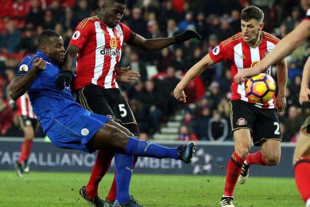 Papy Djilobodji puts pressure on Wes Morgan at the death of Sunderland's win over Leicester