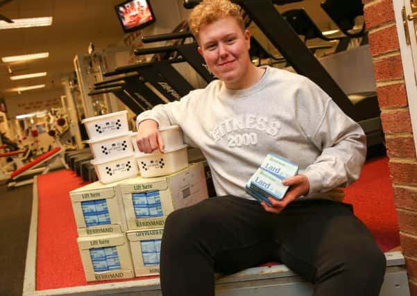 James Struthers, who has lost eight stone in weight since joining the Fitness 2000 gym in Sunderland. He is pictured with eight stone of lard. Picture: TOM BANKS