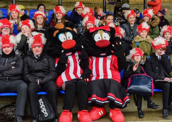 Samson and Delilah with pupis from local schools  grab the best seats to watch Sunderland football team training at Eppleton CW ground, Hetton.