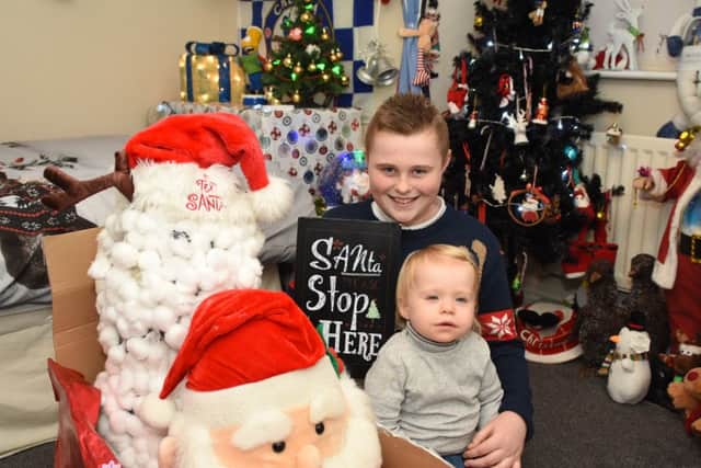 Dylan Simpson, with sister Ava, has turned his bedroom into Santa's Grotto to raise money for St Clares