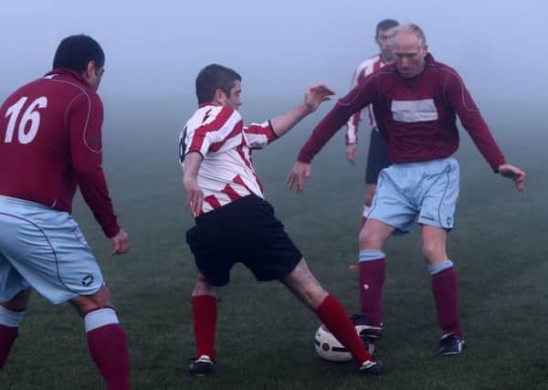Fogbound: Wearmouth CW Juniors (red and white stripes) battle against Colonel Prior. Pictures by Tom Banks