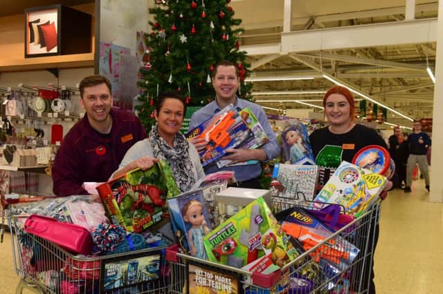 Gavin Foster (3rd left) Managing Editor Sunderland Echo, with l-r Rob Fraser of Sainsbury's, Silksworth Lane, fundraiser Julie Reay (2nd left) and Helen Brown of Sainsbury's with gifts for the Toy Appeal.