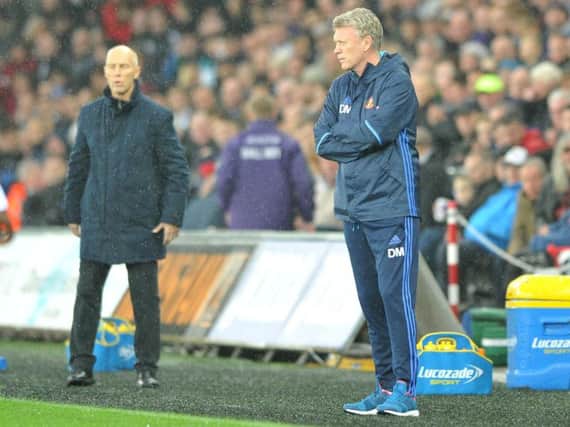 Bob Bradley and David Moyes watch the action unfold.