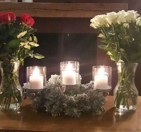 Denise Williamson posted a picture of his display of candles, lit alongside red and white roses.