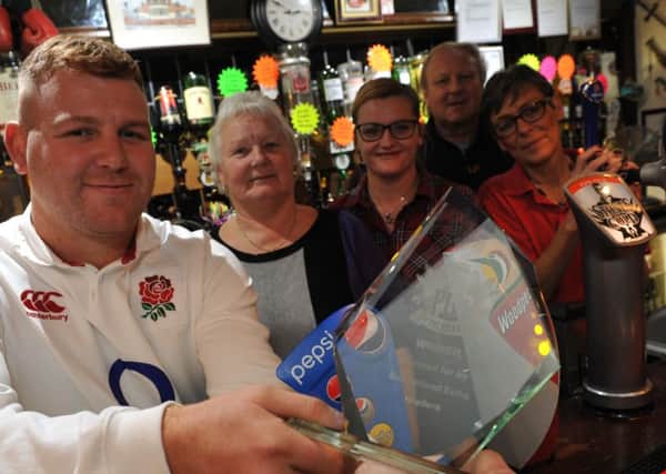 The Dolphin manager Carl Donkin and staff, Miriam Dolan, Gemma Tippling, Judith Brompton, and owner Kelvin Lamb, with their Sunderland Echo Pub of the Year award.