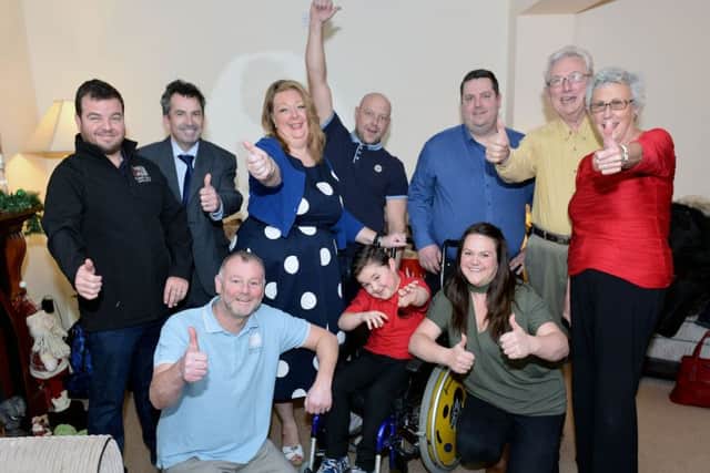 Matthew Brettell with his Mum Maria (front right) and Vivian Watts of Hope4Kidz (centre) along with builders, contributors and fundraisers.  Picture by FRANK REID