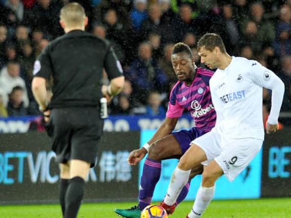 Lamine Kone in action against Swansea City.