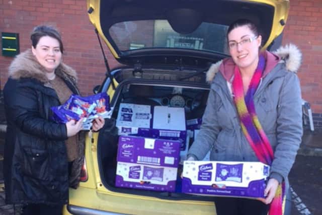 Natalie Gorman, of Computer Share at Doxford International, helps Amy, from Hope 4 Kidz, load the car with goodies for the Echo Toy Appeal