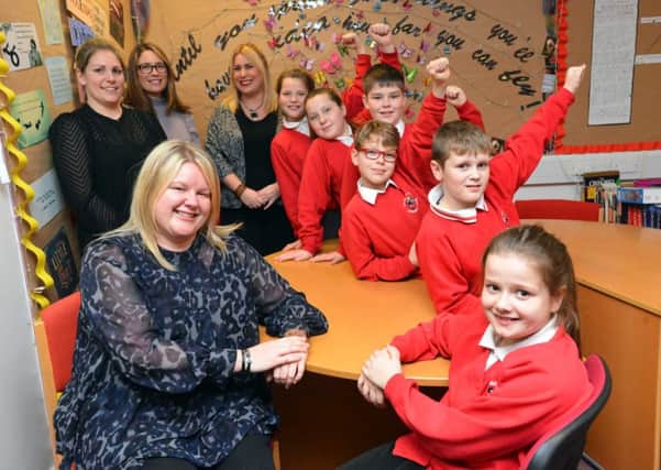 Headteacher Natalie Fountain and pupil Trinity Moorland, ten, (pictured front) celebrate St Paul's CE Primary School's Key Stage 2 Sats results