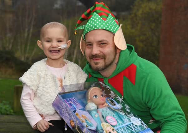 Lottery winner Kenny Ashton gives Hope Feeney (who suffers with neuroblastoma) a Christmas treat.