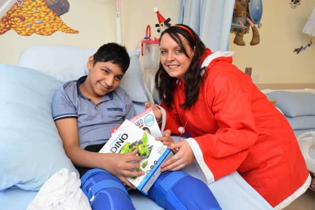 Fundraiser Emma Olsen hands out Christmas present's on the children ward at Sunderland Royal Hospital.
Muhammad Hussan, 13