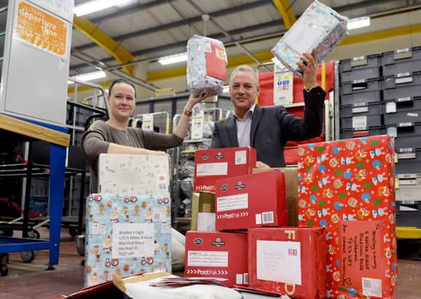 Lynn Murphy (campaign manager) and Mark Wilkinson (deliveries director northeast region) with a small selection of cards and presents for Bradley Lowery.  Picture by FRANK REID