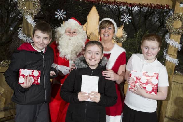 Santa and Mrs Claus are pictured with students Calum, 11, Chelsie, 12, and Jessica, 11, in the grotto.