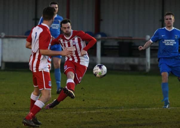 Seaham Red Star's Craig Lynch (red) has a crack at goal in last week's Division One win over Dunston UTS. Picture by Kevin Brady