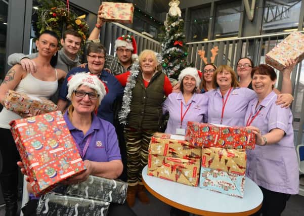 Manager Christine Ritchie, front, with staff and residents of Swan Lodge, who have been thrilled at the donations to the home for Christmas.